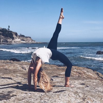 full wheel yoga pose on the beach