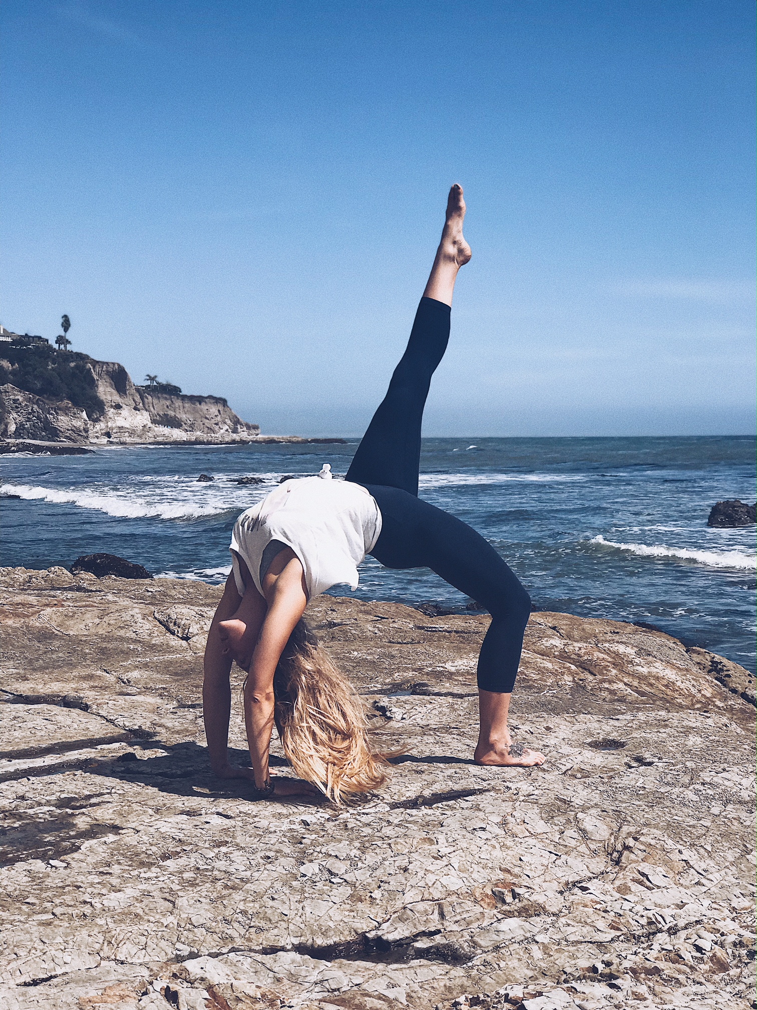 full wheel yoga pose on the beach